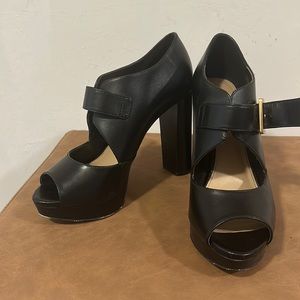 Black Michael Kors buckle heels.